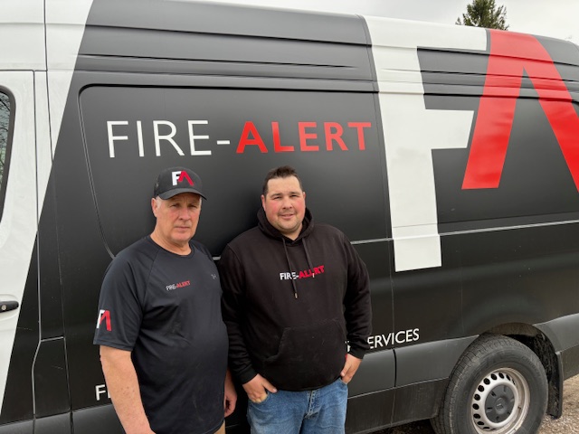 Brad and his son in front of the Fire-Alert service van