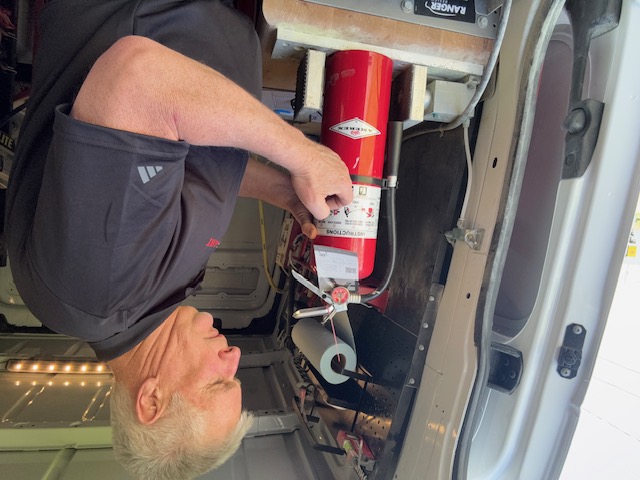 Brad Ayres inspecting an extinguisher tag
